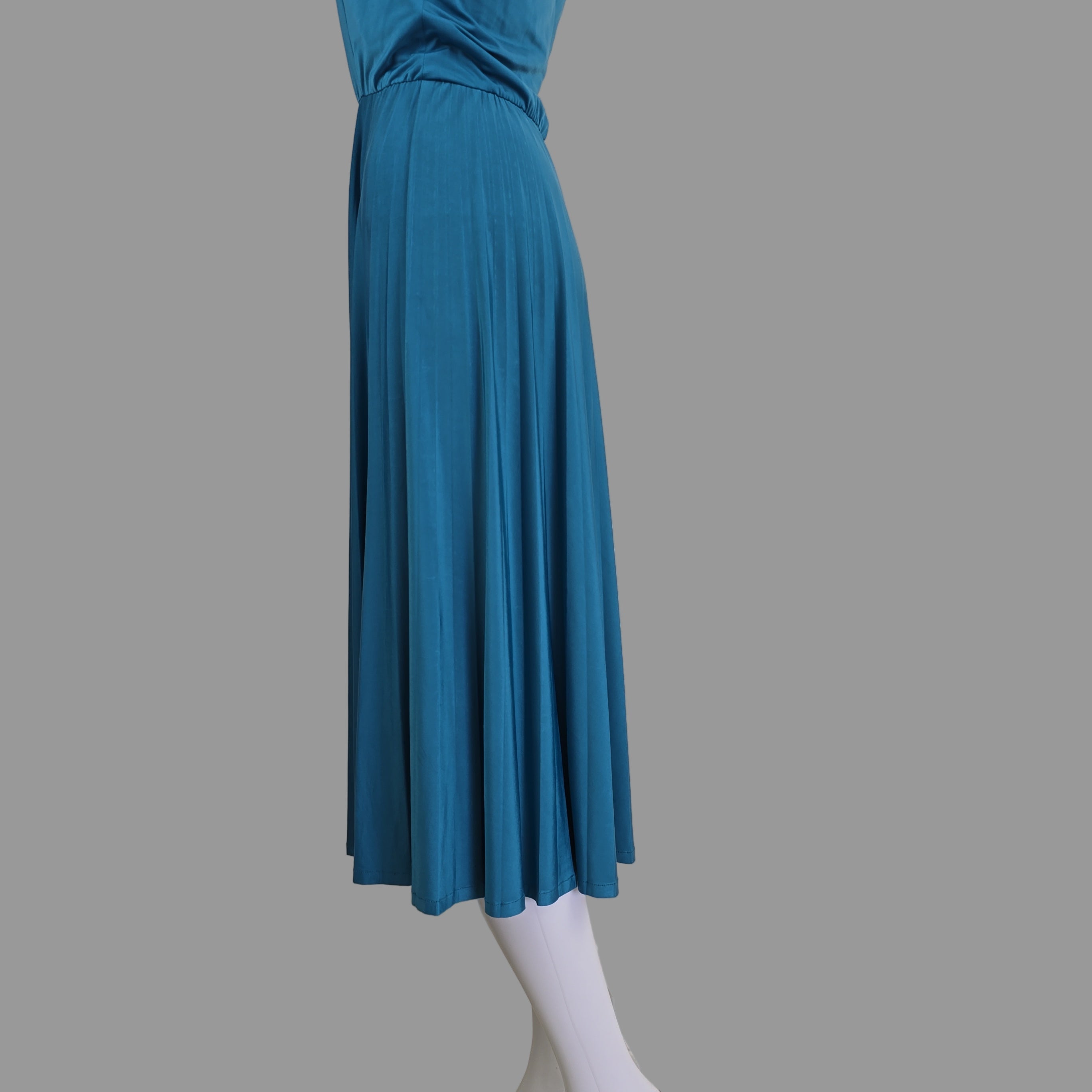 Blue pleated skirt with white hem against a neutral background