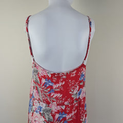 Red floral top on a mannequin against a plain background