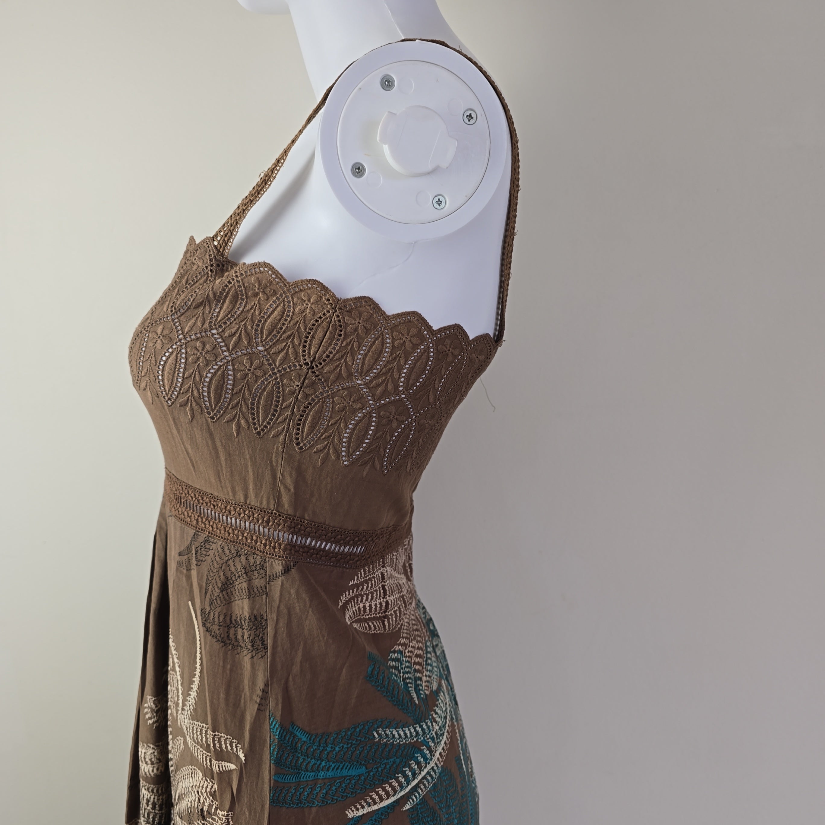 Brown embroidered top on a white background