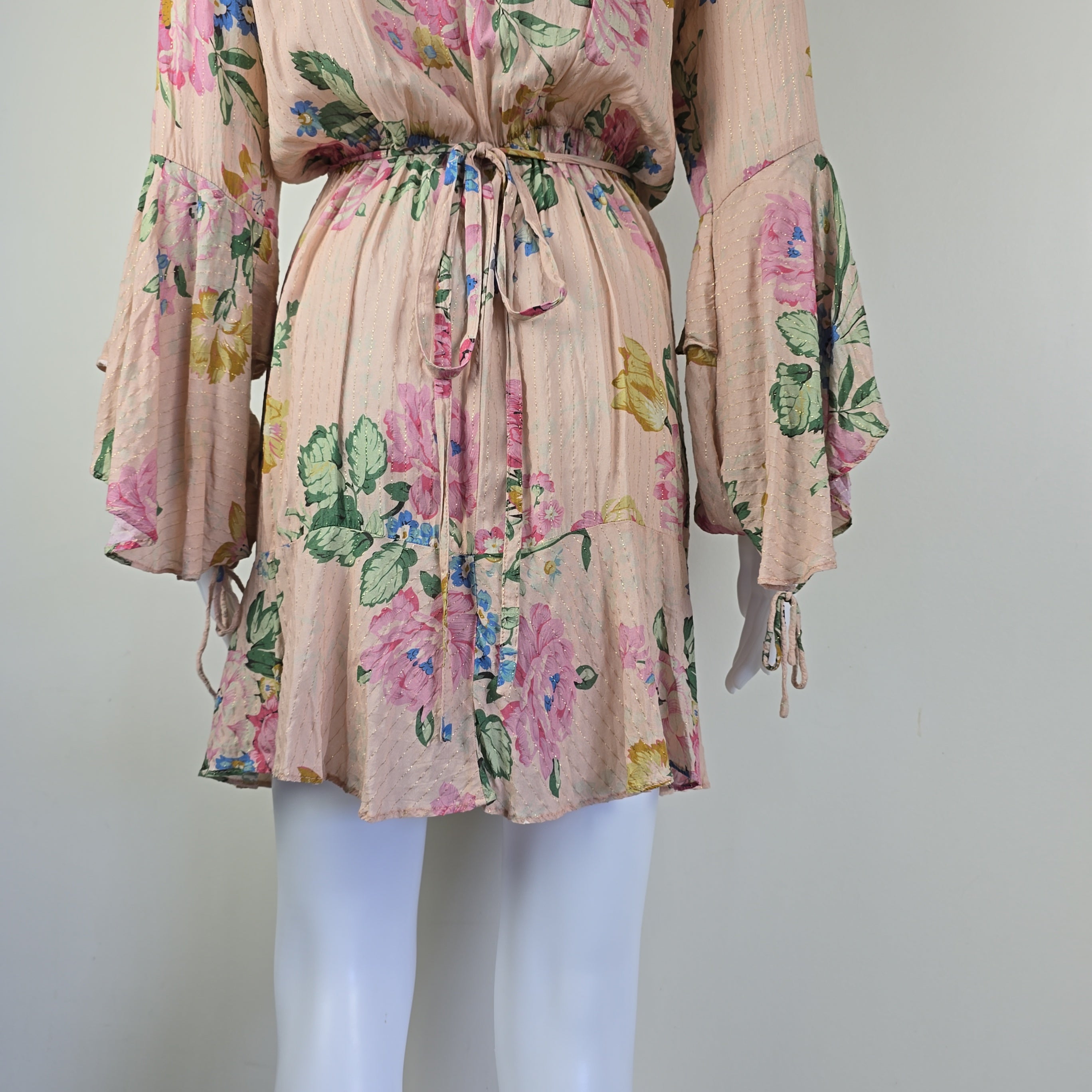 Floral dress on a mannequin against a plain background