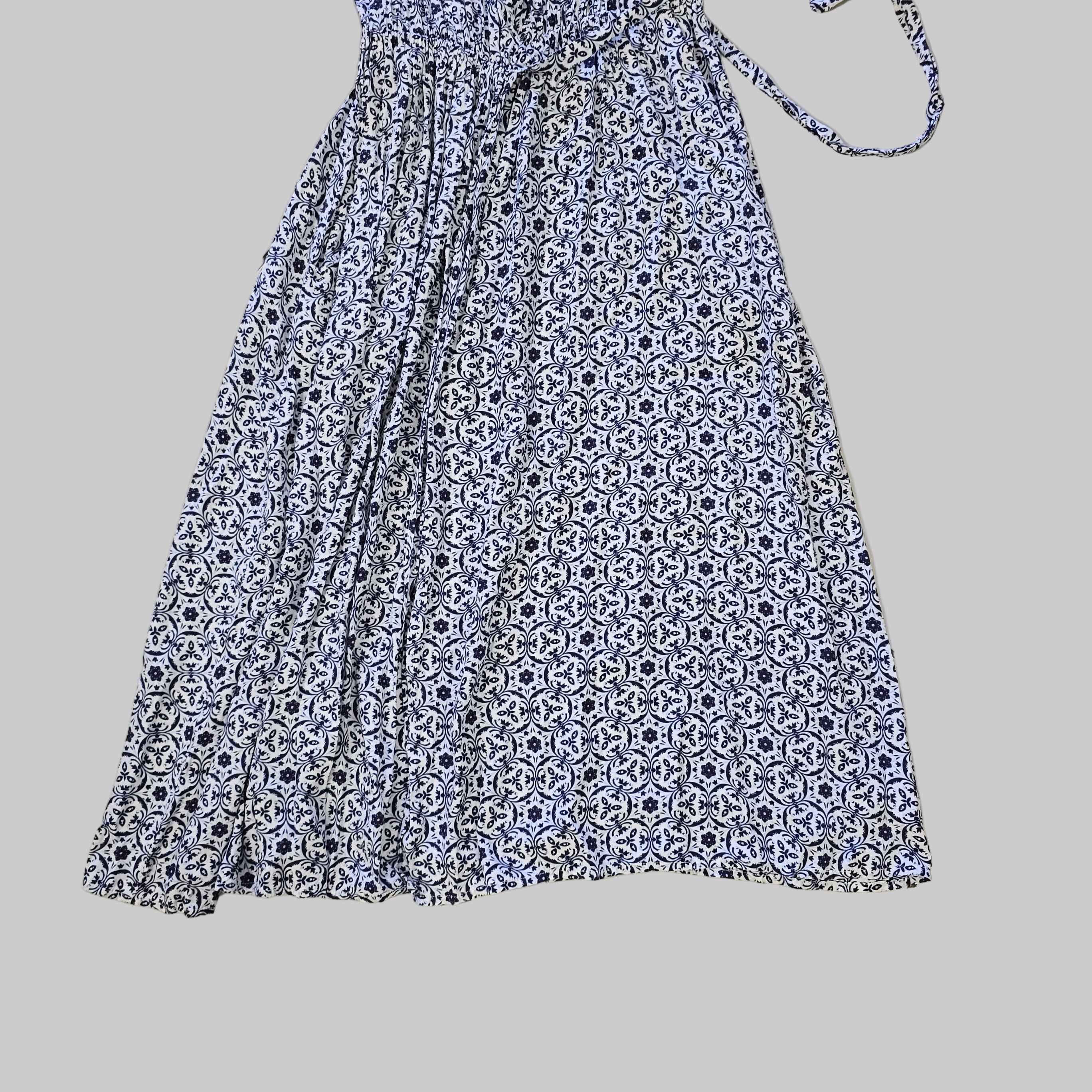 Blue and white patterned dress on a tiled floor