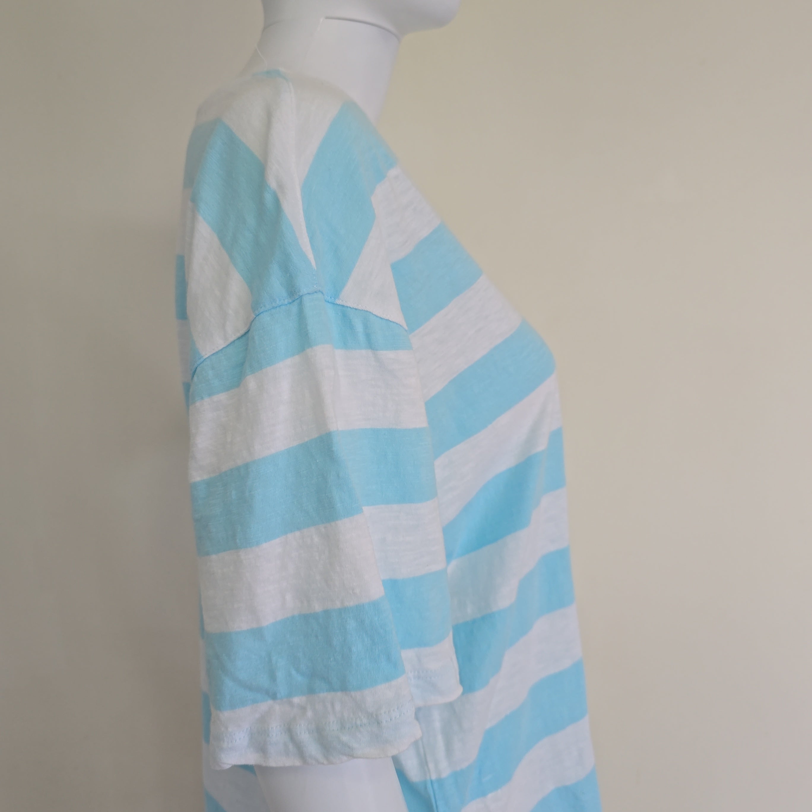 Light blue and white striped shirt on a light background