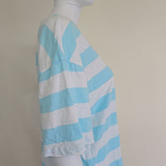 Light blue and white striped shirt on a light background