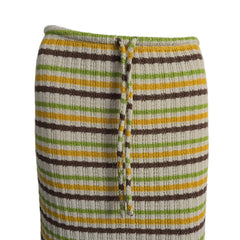 Striped fabric with green, yellow, and brown colors on a mannequin.