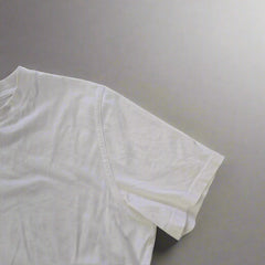 White t-shirt on a tiled floor