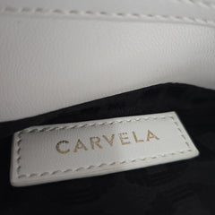 Close-up of a 'Carvela' label on a product with a white and black background.