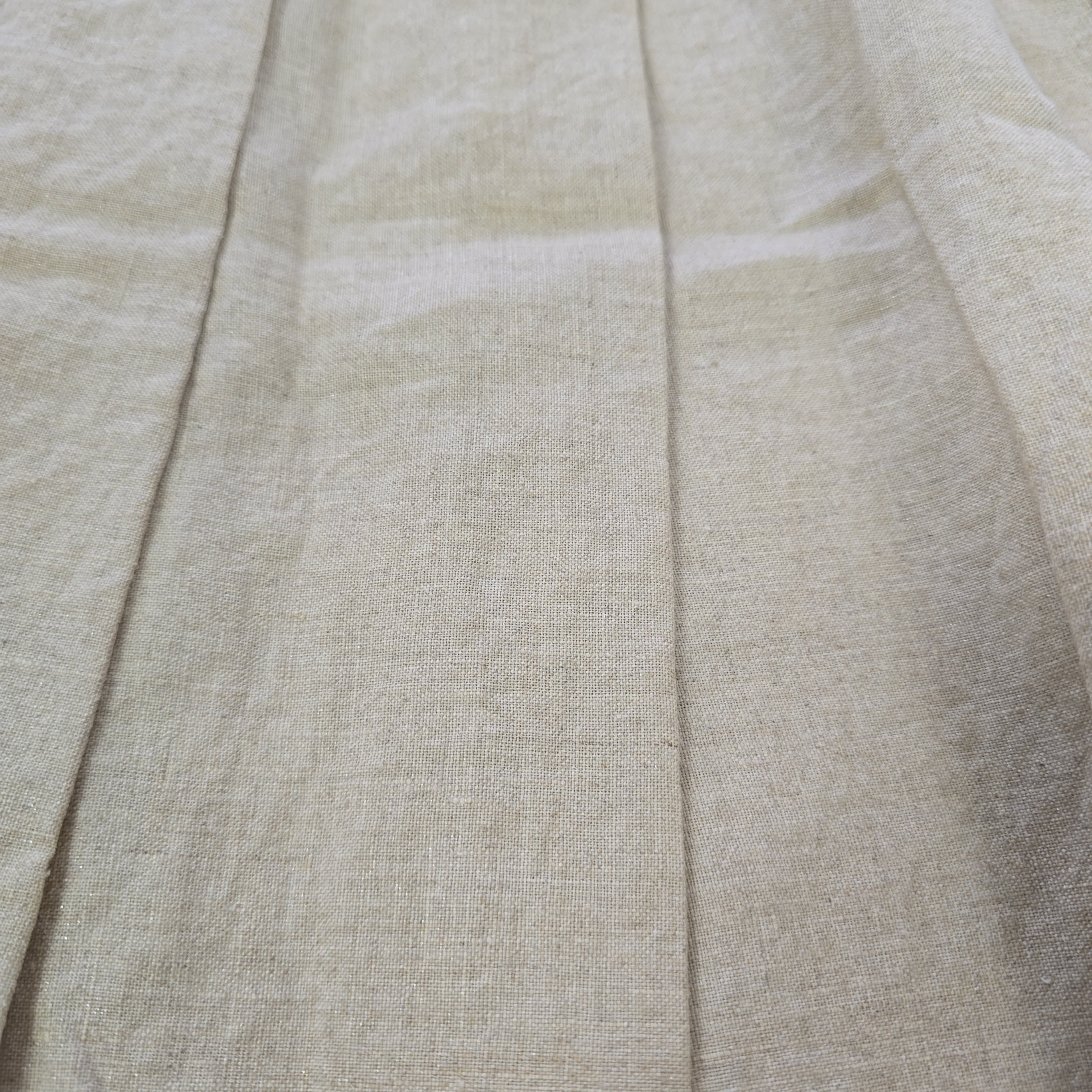Close-up of beige fabric with visible stitching