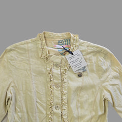 Light-colored jacket with a tag on a neutral background
