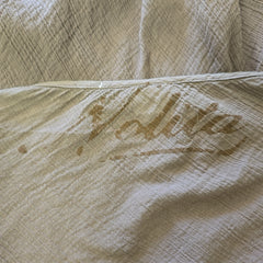 Close-up of a brown fabric with 'Nolita' text printed on it