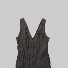 Dark-colored sleeveless dress on a tiled floor