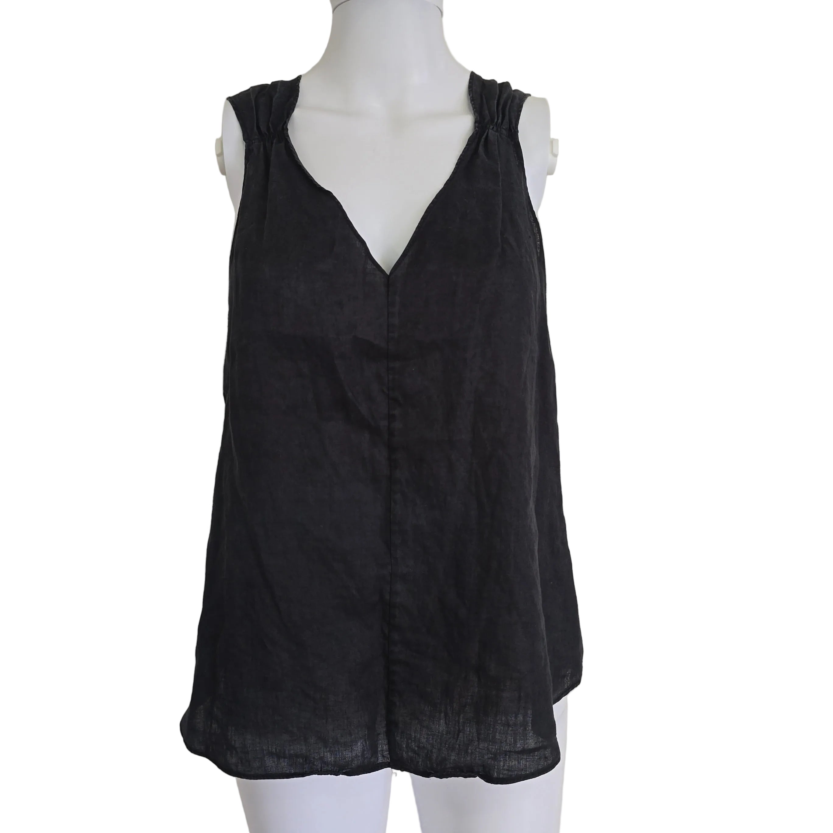 Black top on a mannequin against a beige background