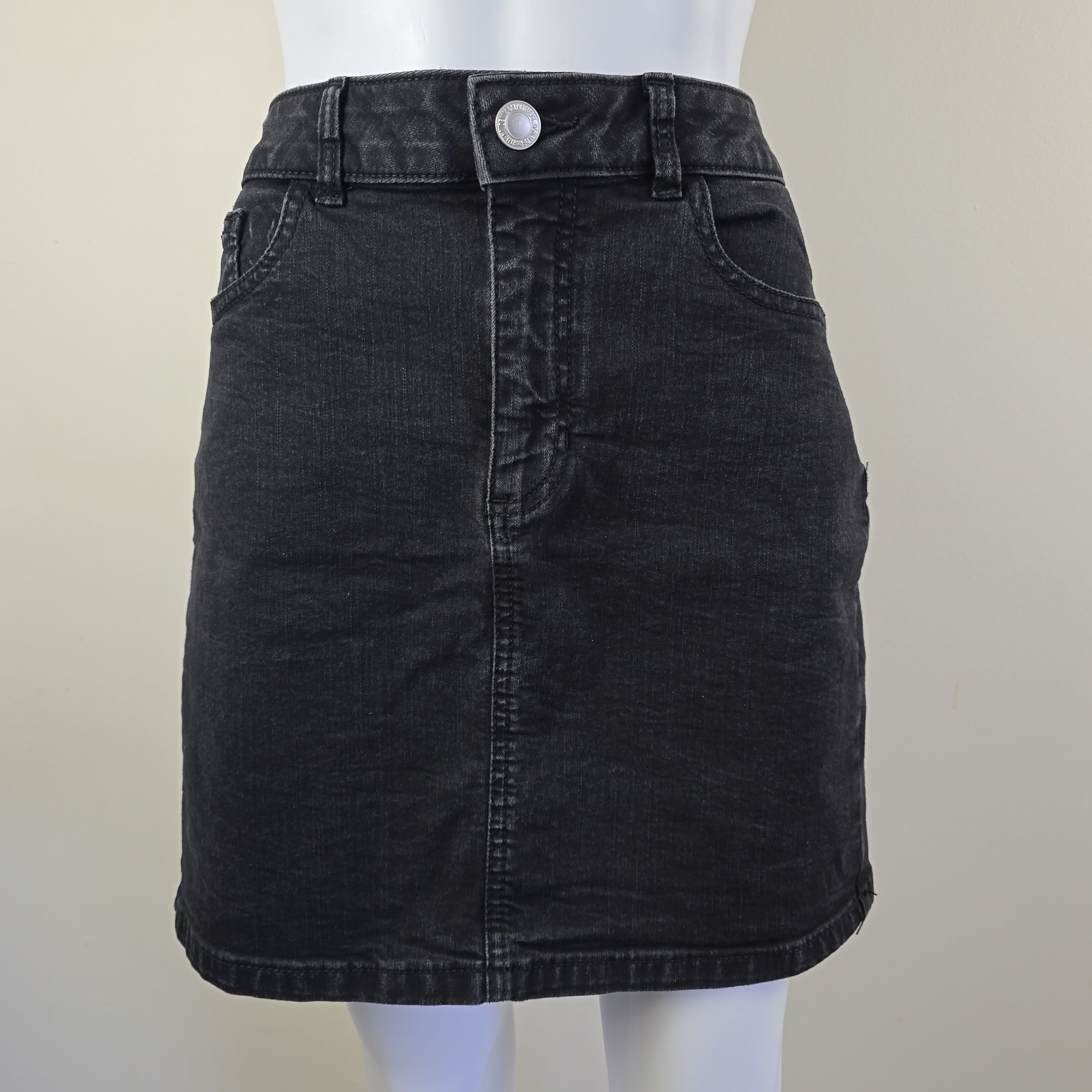 Black denim skirt on a white background