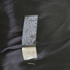 Clothing tag on a dark fabric background
