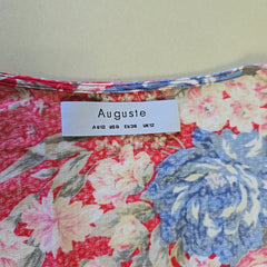 Floral fabric with a label that reads 'Auguste' on a beige background