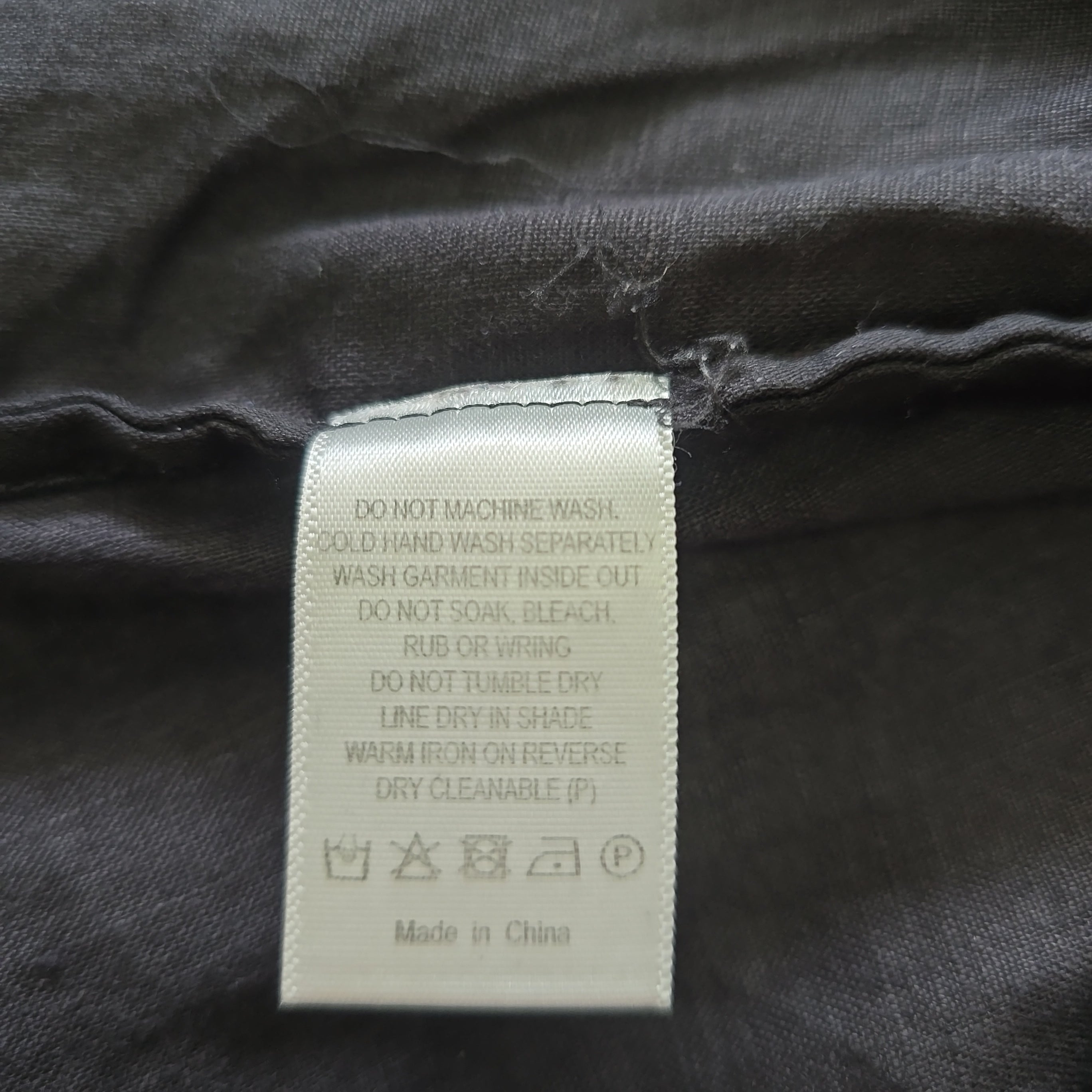 Clothing label on a dark fabric background