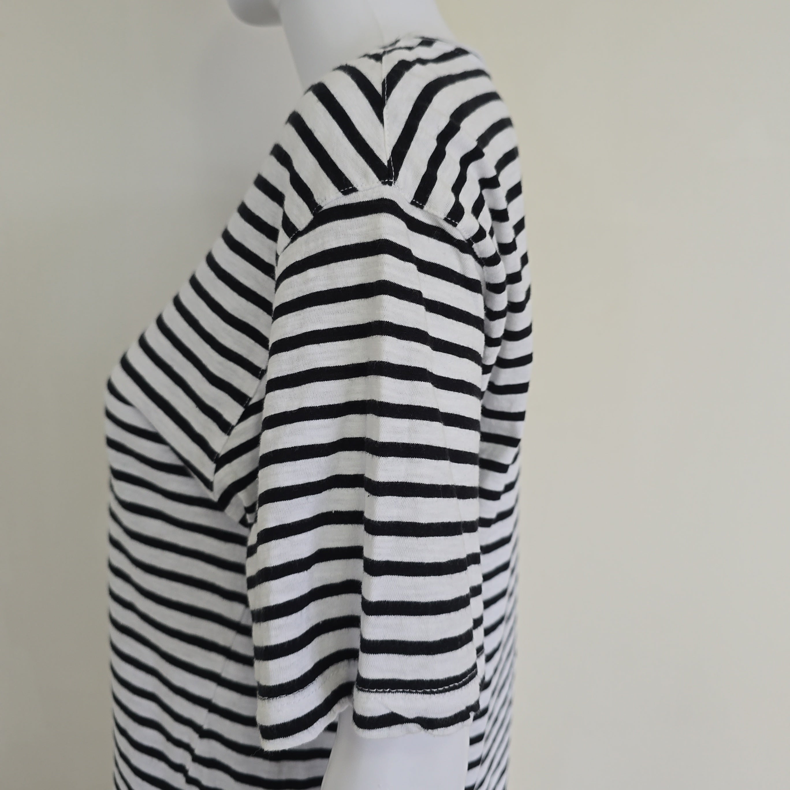 Black and white striped fabric on a mannequin with a plain background