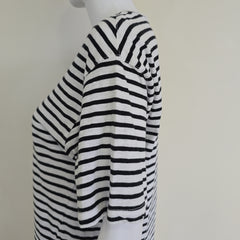 Black and white striped fabric on a mannequin with a plain background