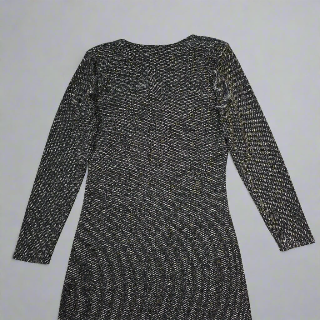 Black and gold textured dress against a light gray background