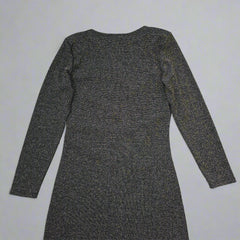 Black and gold textured dress against a light gray background