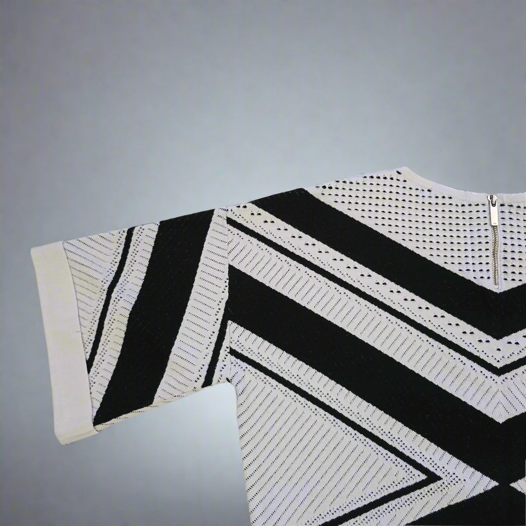 Black and white stripedtop on a gray background