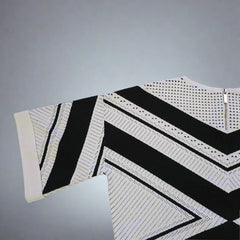 Black and white stripedtop on a gray background