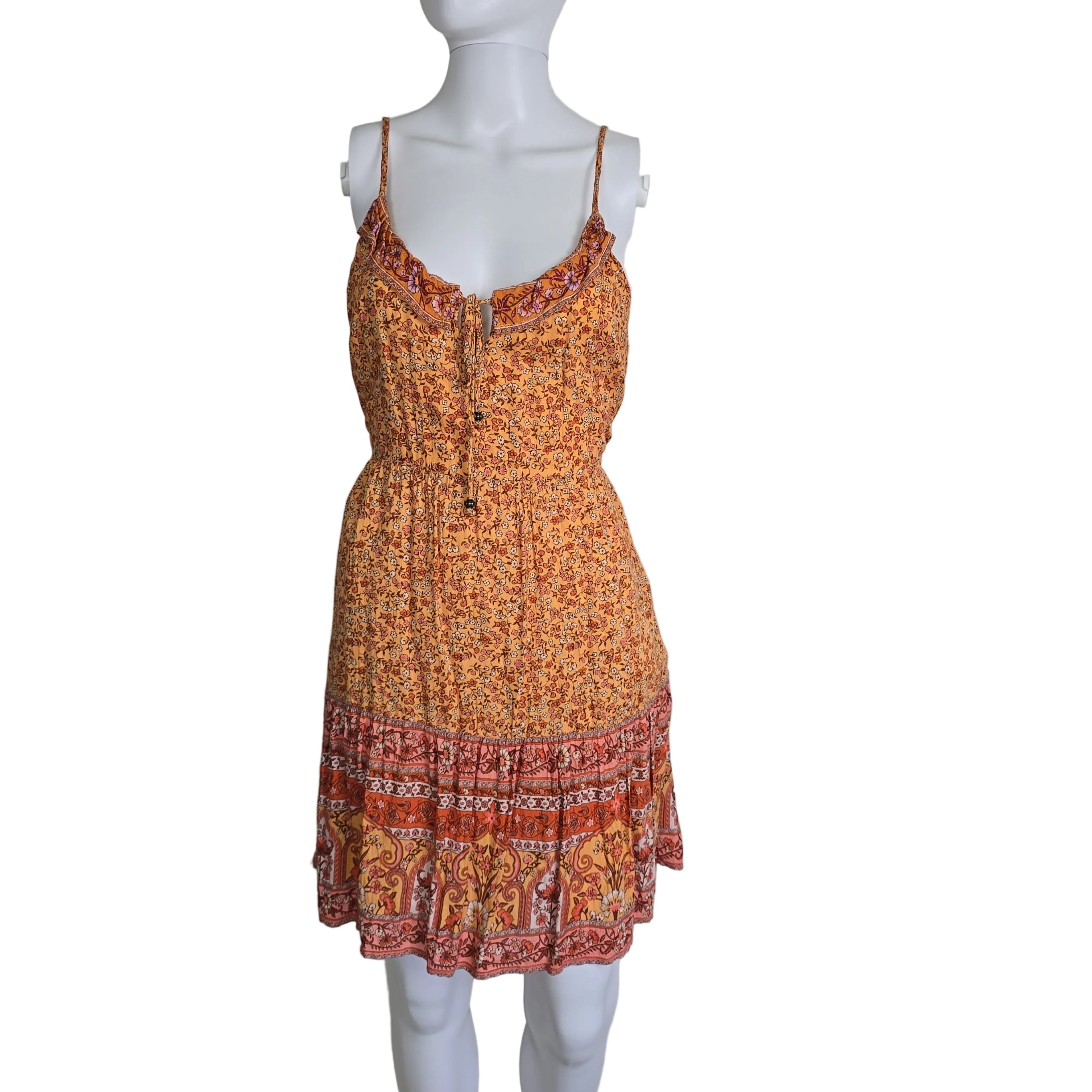Mannequin wearing a patterned dress with a plain background