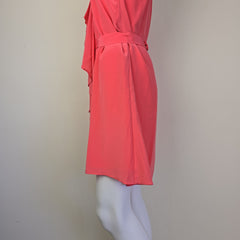 Pink dress on a mannequin against a plain background