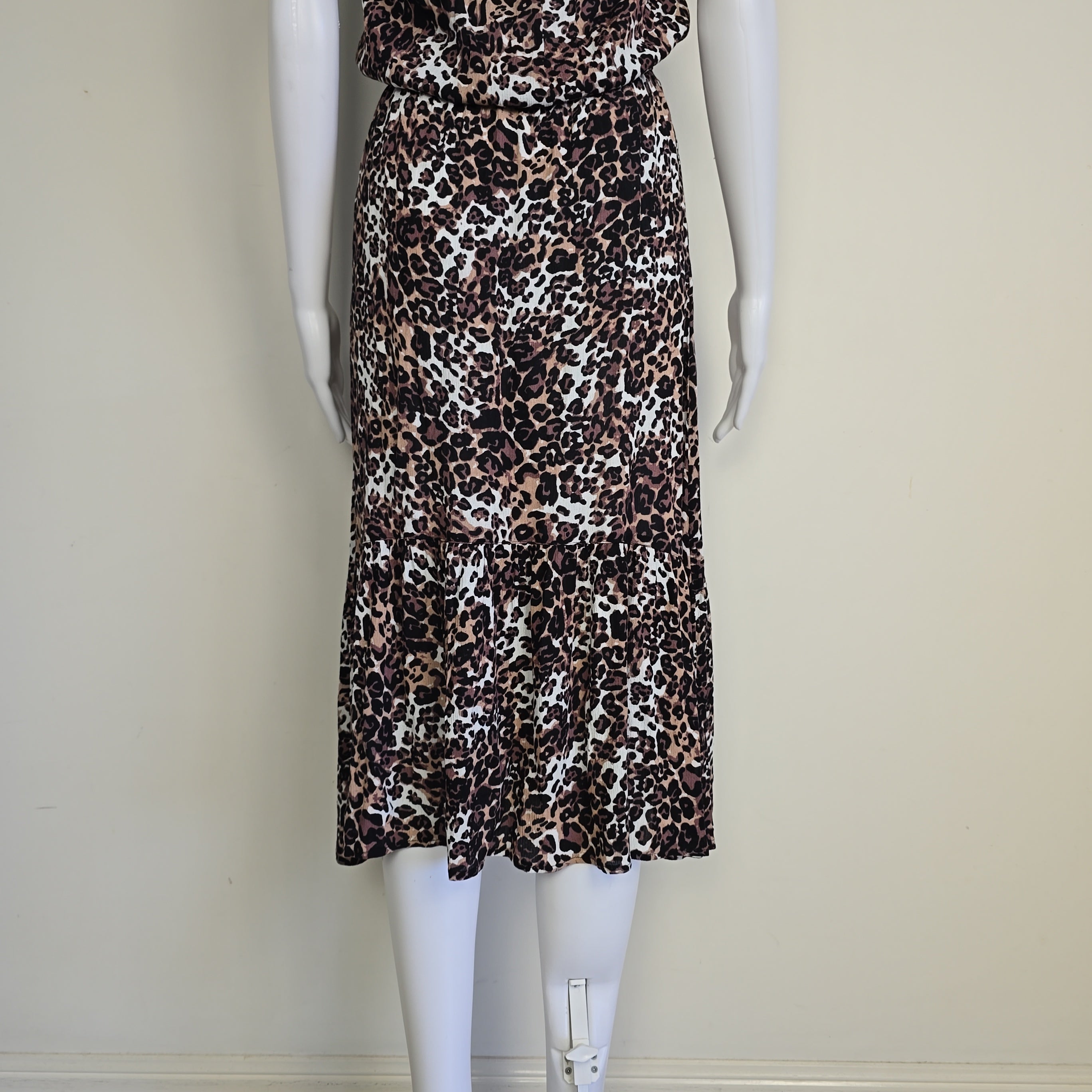 Leopard print dress on a mannequin against a plain background