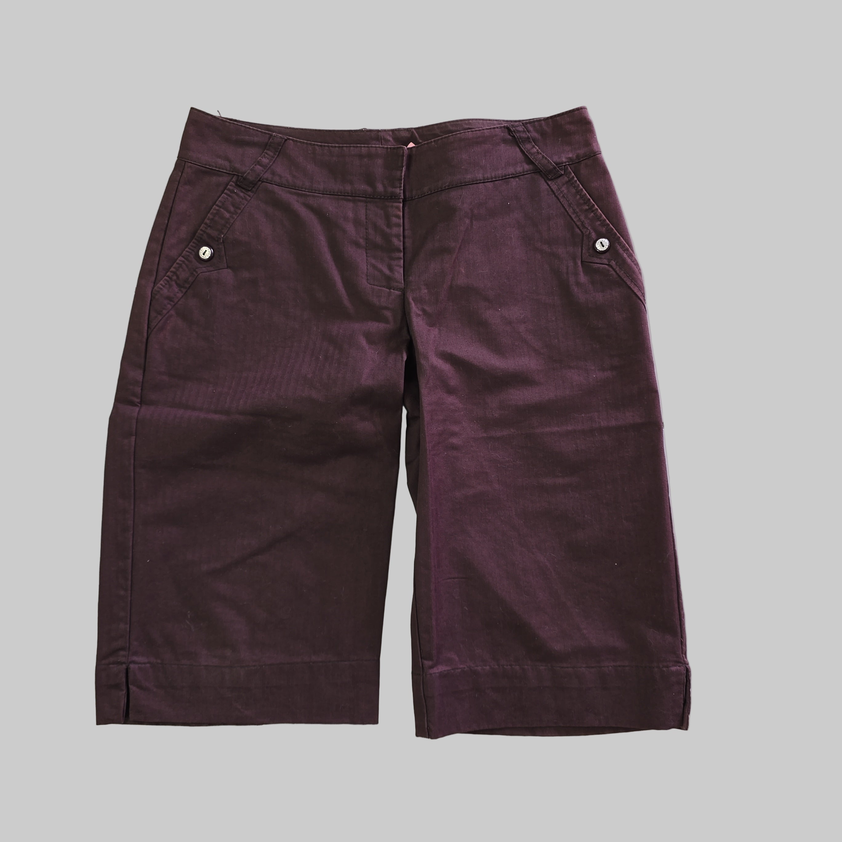 Pair of purple shorts on a light background
