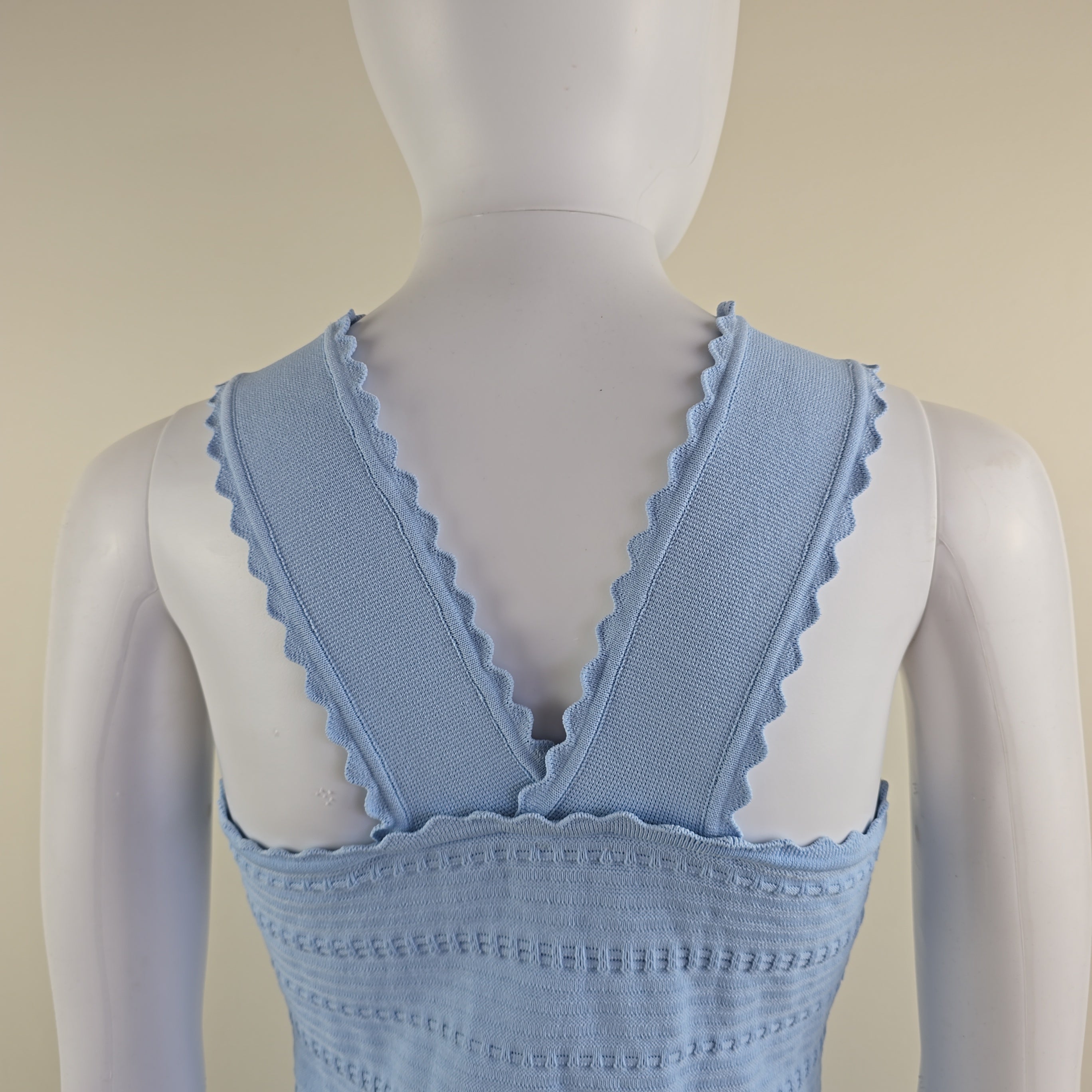 Light blue dress on a mannequin against a beige background