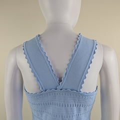 Light blue dress on a mannequin against a beige background