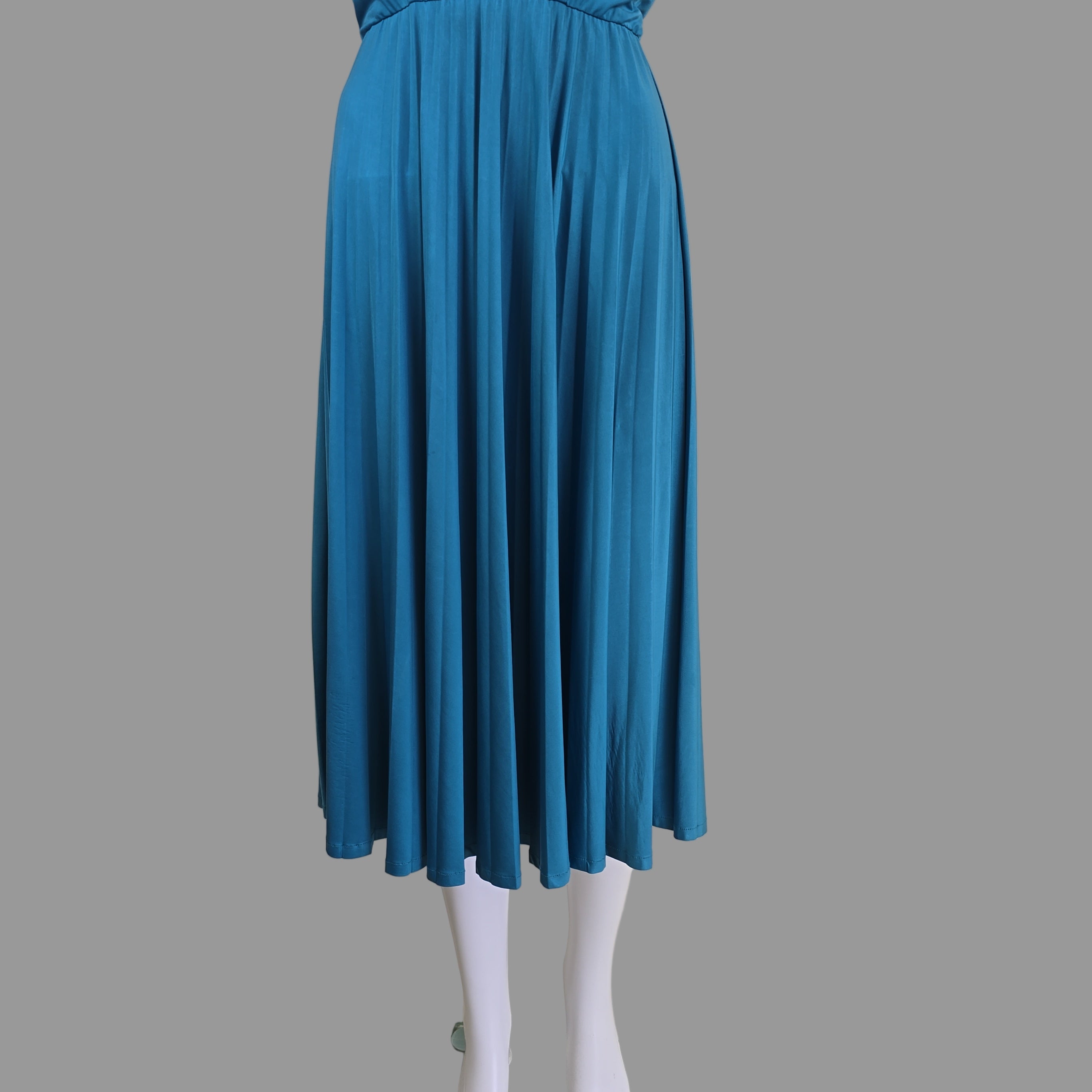 Blue pleated dress on a mannequin against a plain background