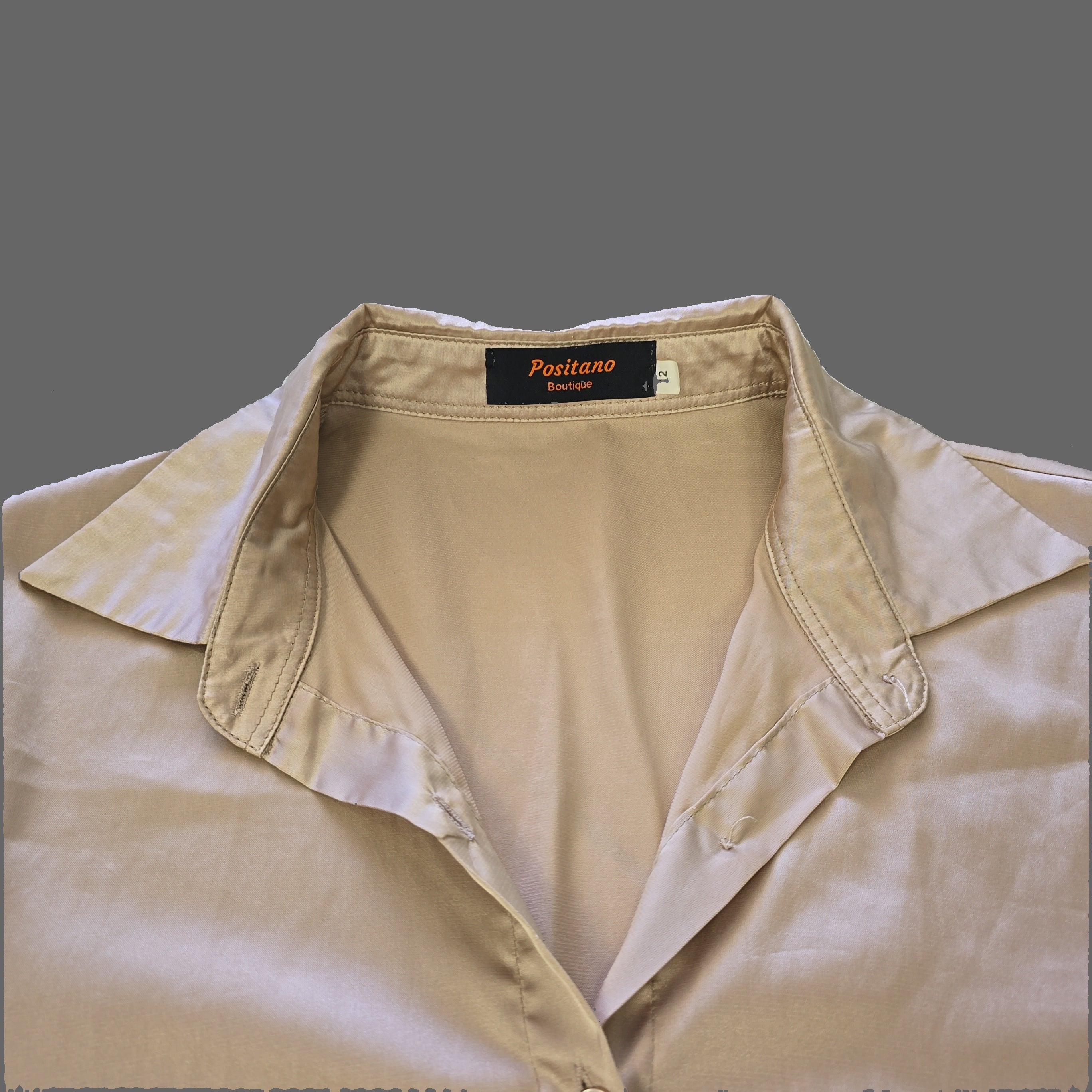 Beige top with a brand label on a white background