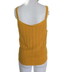 Yellow knitted vest on a mannequin against a plain background
