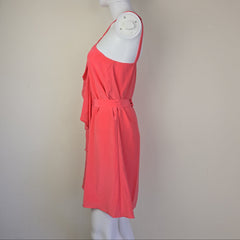 Pink dress on a mannequin against a plain background