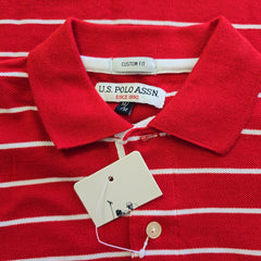 Red and white striped shirt with U.S. Polo Assn. tags on a red background