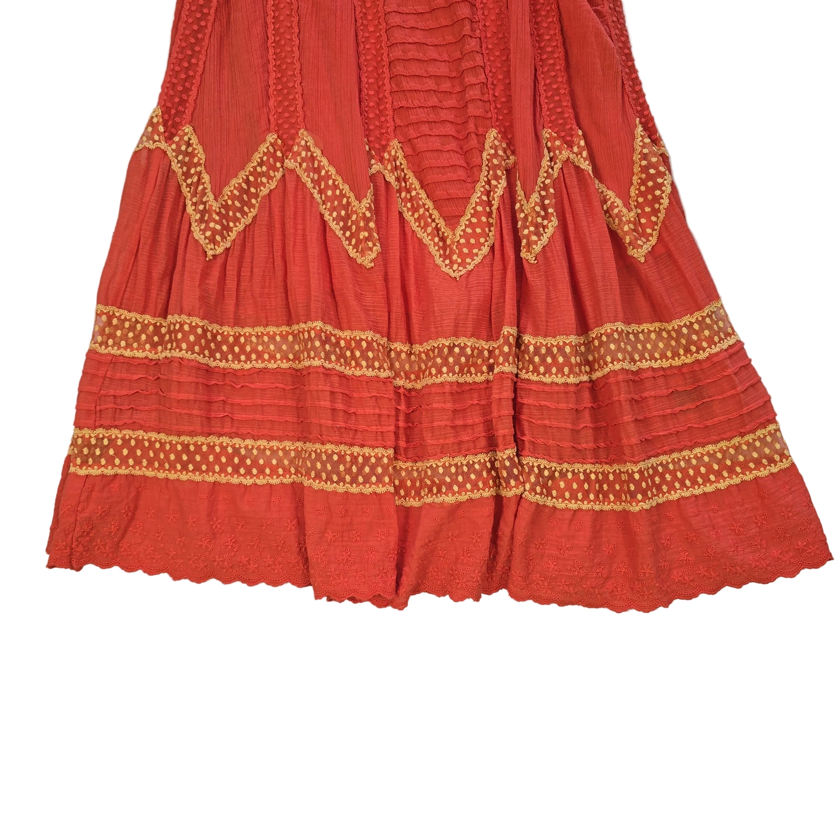 Orange dress with yellow embroidery on a light background