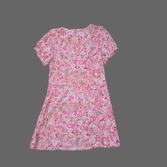 Pink floral dress on a tiled floor