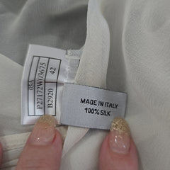 Clothing label on a fabric with a hand holding it