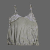 Light gray satin top on a tiled floor