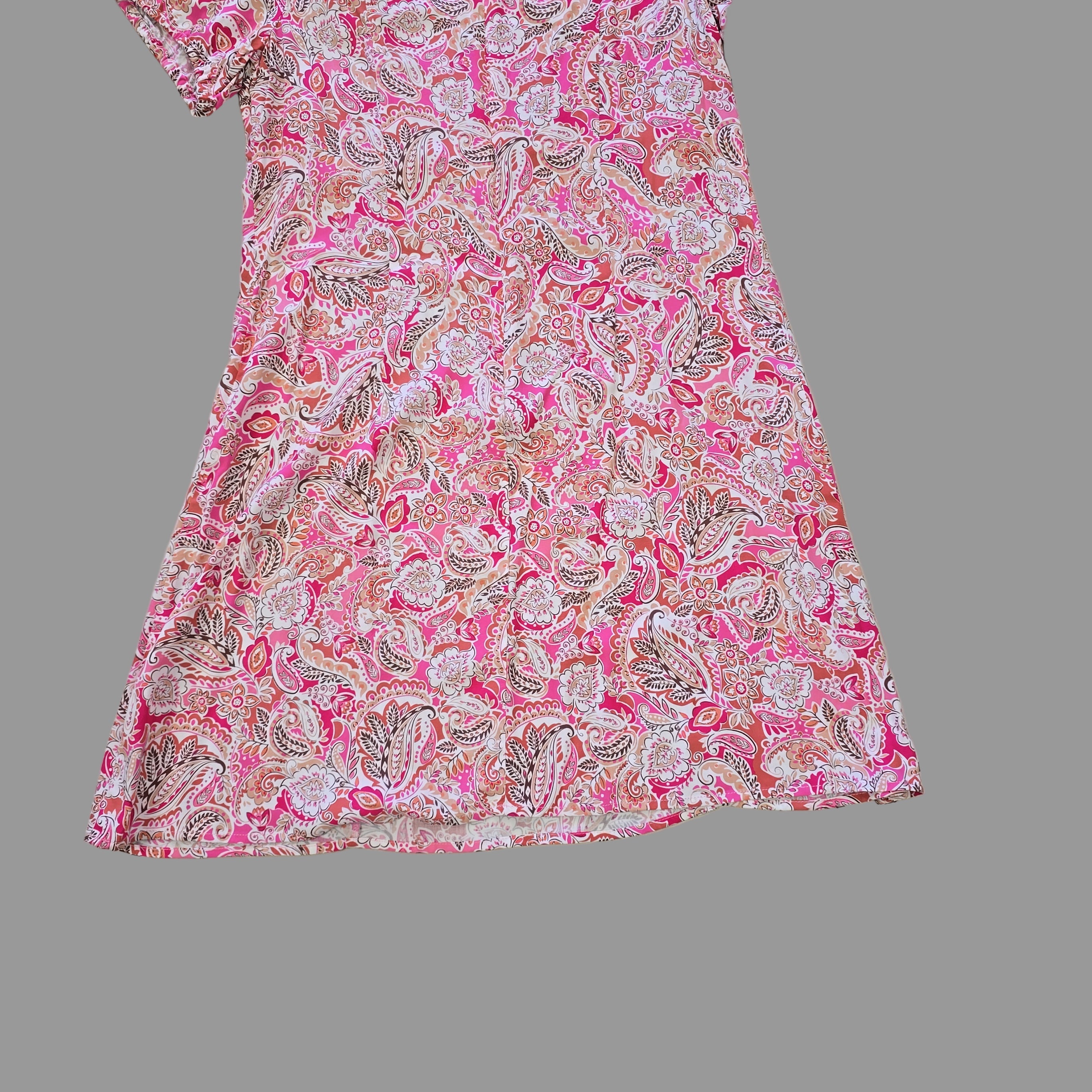 Pink paisley fabric on a tiled floor