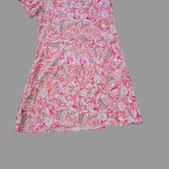 Pink paisley fabric on a tiled floor