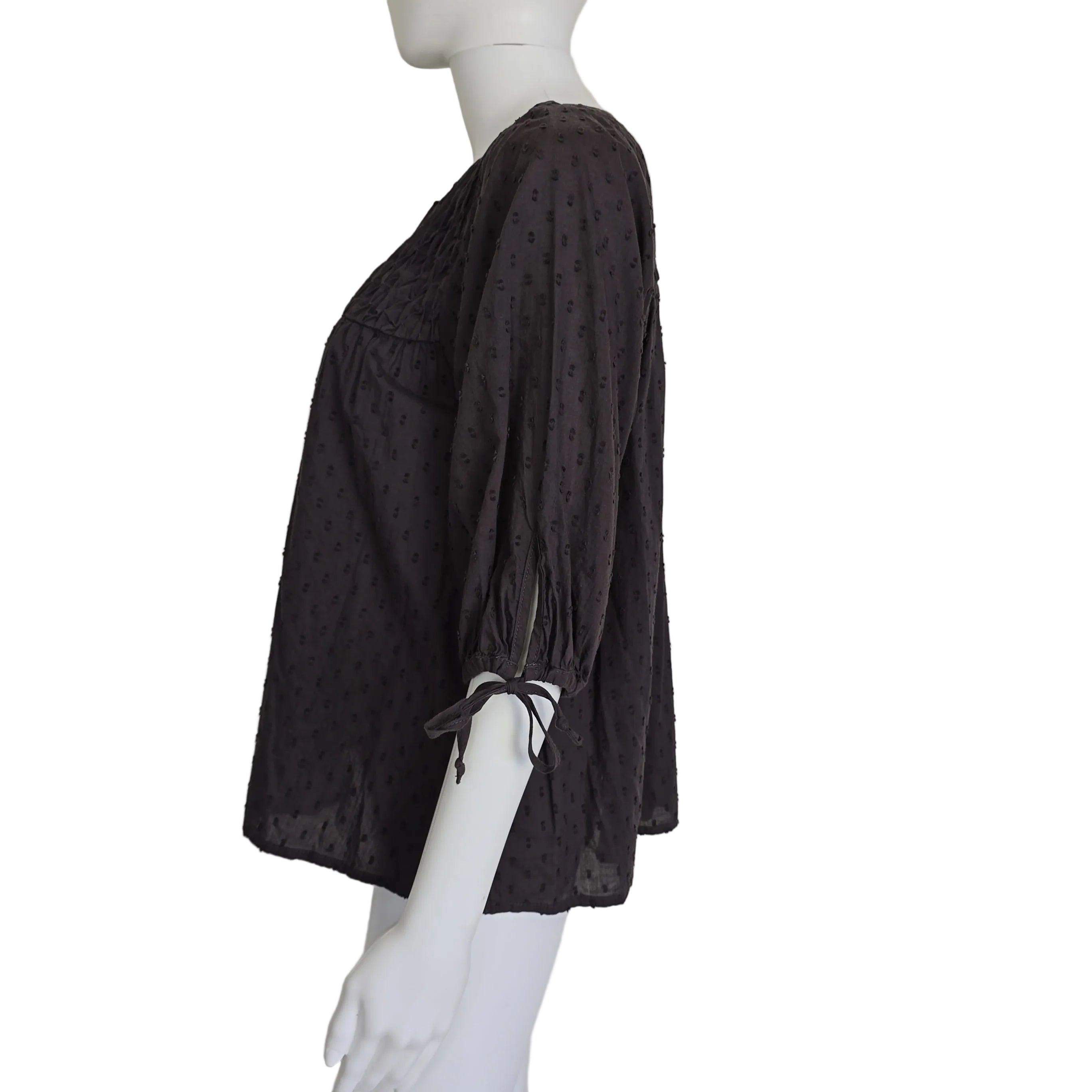 Brown textured top on a mannequin against a beige background