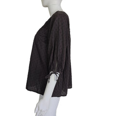 Brown textured top on a mannequin against a beige background