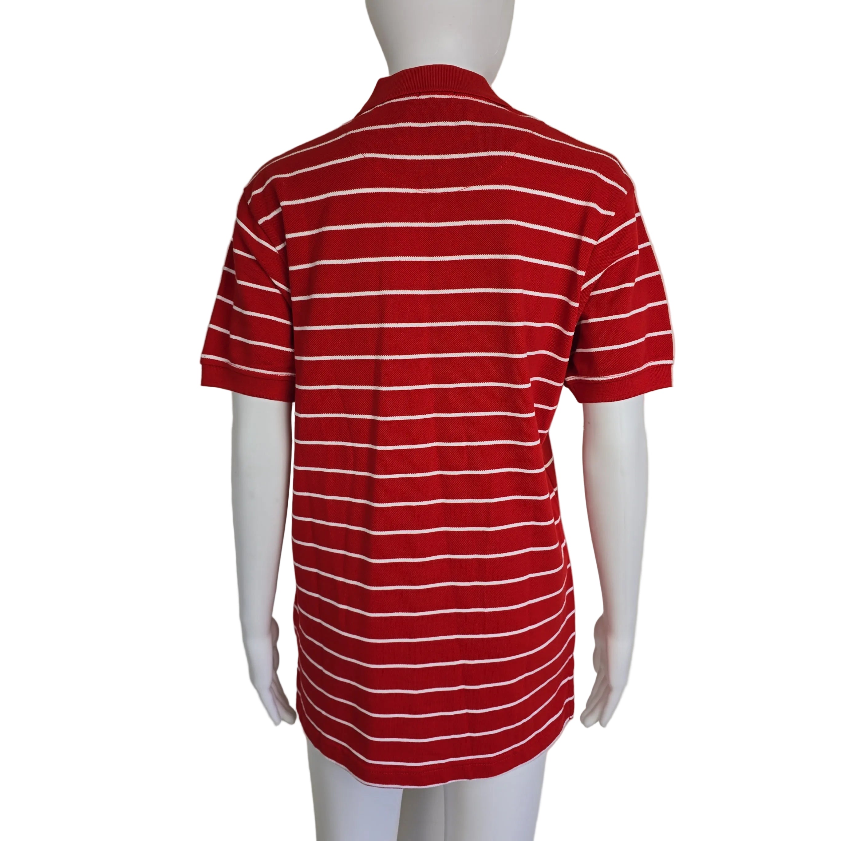 Red and white striped garment on a mannequin against a beige background