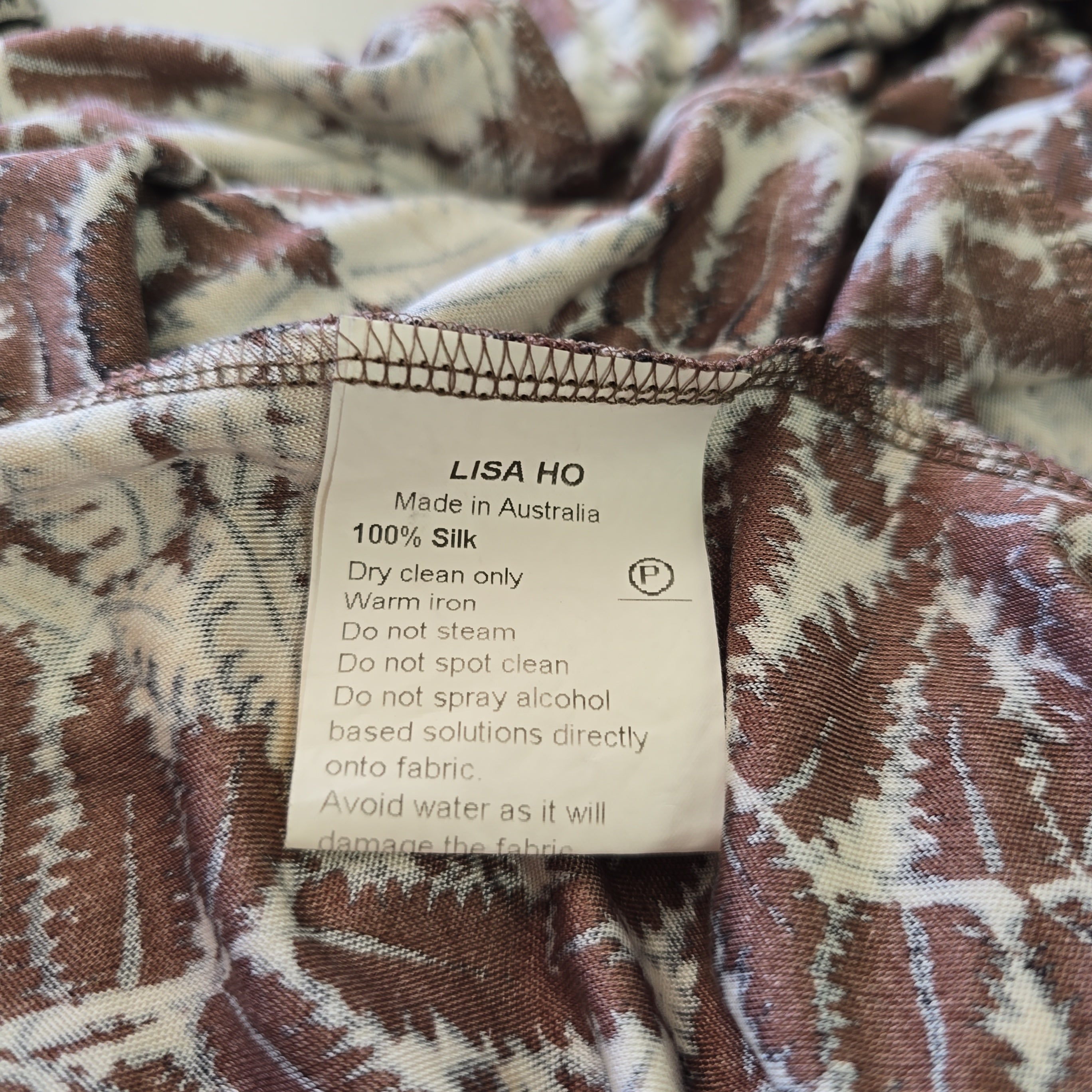 Close-up of a patterned fabric with a label on a white background