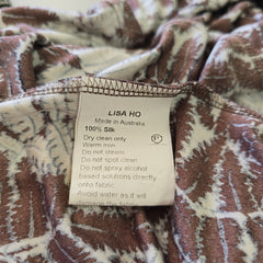 Close-up of a patterned fabric with a label on a white background