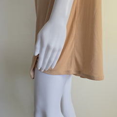 Mannequin wearing a beige top on a plain background