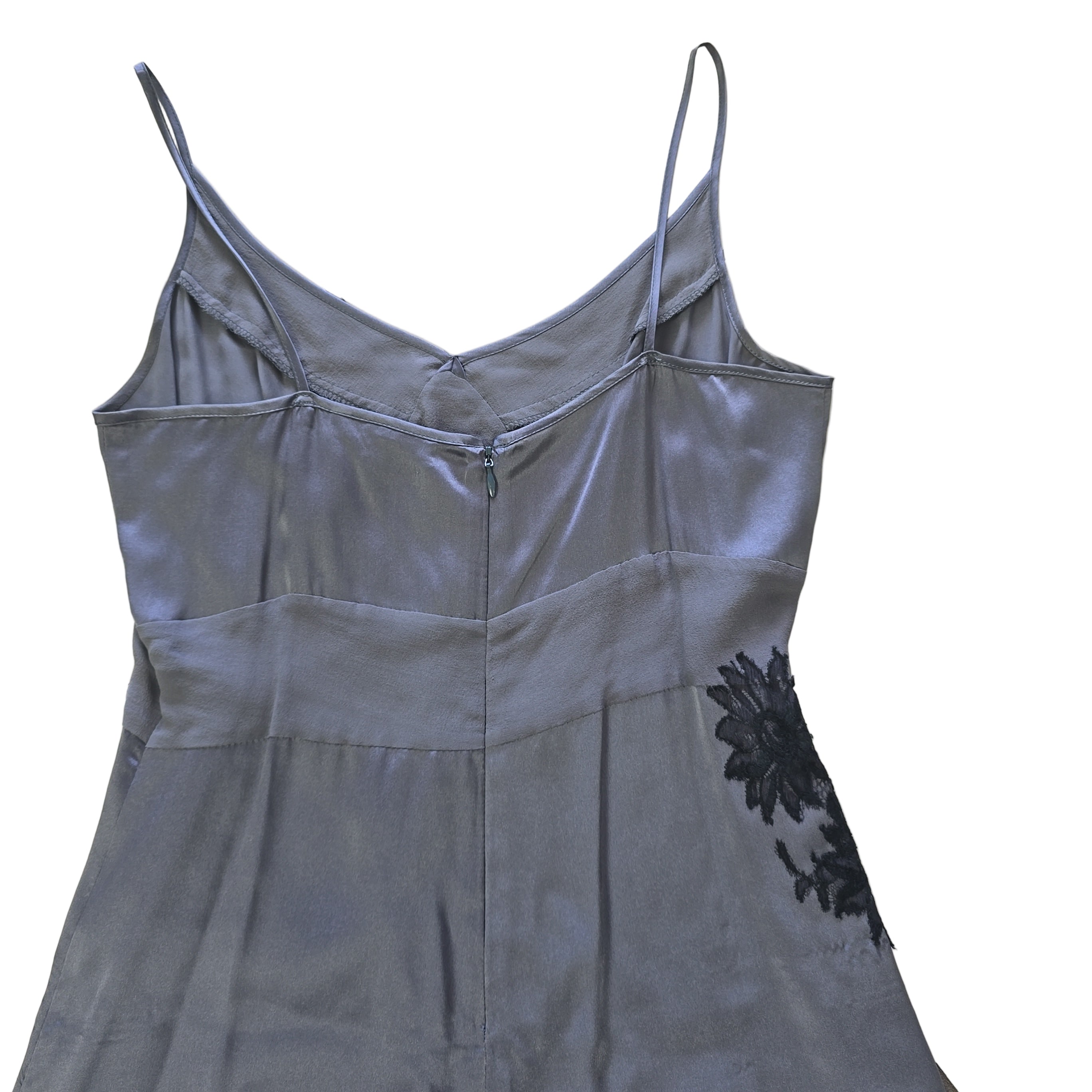 Gray dress with black lace details on a tiled floor