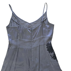 Gray dress with black lace details on a tiled floor